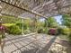 Covered patio with a wooden pergola surrounded by lush landscaping and a view of the backyard at 1008 Maduro Ct, Zebulon, NC 27597