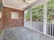 Inviting screened porch featuring stone floors and a ceiling fan offering a relaxing outdoor space with a view of the lush yard at 1008 Maduro Ct, Zebulon, NC 27597