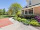 A sidewalk leads to this brick home that features beautiful landscaping and a screened porch at 1008 Maduro Ct, Zebulon, NC 27597