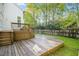 Wood deck and backyard with green lawn and tall trees at 102 Cockleshell Ct, Cary, NC 27513