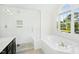 Beautiful bathroom with a glass shower, soaking tub, and window view at 102 Cockleshell Ct, Cary, NC 27513