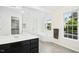 Bright bathroom featuring a large window, tub, and closet at 102 Cockleshell Ct, Cary, NC 27513