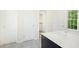 Bright bathroom with tile flooring, closet, and vanity area at 102 Cockleshell Ct, Cary, NC 27513