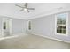 Large bedroom with carpet, a ceiling fan, and plenty of natural light at 102 Cockleshell Ct, Cary, NC 27513