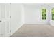 Bright bedroom with neutral carpet and windows with backyard views at 102 Cockleshell Ct, Cary, NC 27513