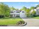 Charming two-story white home with a well-maintained lawn and driveway leading to the attached garage at 102 Cockleshell Ct, Cary, NC 27513