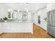 Stylish white kitchen with granite countertops, stainless steel appliances, and hardwood floors for a clean look at 102 Cockleshell Ct, Cary, NC 27513