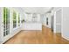 Modern white kitchen with stainless steel appliances, elegant countertops, and large windows overlooking the yard at 102 Cockleshell Ct, Cary, NC 27513