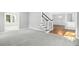 Open floor plan with carpet, staircase, and a view into another room at 102 Cockleshell Ct, Cary, NC 27513
