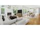 Inviting open-concept layout with a cozy living area, modern furniture, and white kitchen with an island at 102 Cockleshell Ct, Cary, NC 27513