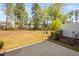 View of the backyard showing the patio and wooded area beyond at 1020 Sycaten St, Durham, NC 27703