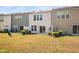 This backyard is lined with trees and a privacy fence with a concrete patio at 1020 Sycaten St, Durham, NC 27703