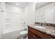 Bathroom with a shower-tub combo, granite countertops, a dark wood vanity, and a mirror at 1020 Sycaten St, Durham, NC 27703