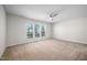 Bedroom features carpeted floors, a ceiling fan, and three windows with lots of natural light at 1020 Sycaten St, Durham, NC 27703