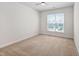 Bright bedroom with large window providing lots of natural light and neutral carpet at 1020 Sycaten St, Durham, NC 27703