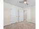 Cozy bedroom with a ceiling fan, neutral carpet, and access to the closet at 1020 Sycaten St, Durham, NC 27703
