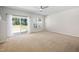 Bedroom featuring neutral paint, carpet, ceiling fan, and sliding glass doors to the backyard at 1020 Sycaten St, Durham, NC 27703