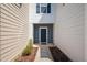 Welcoming townhome entrance with a dark blue door and landscaped walkway, enhancing curb appeal at 1020 Sycaten St, Durham, NC 27703