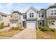 Well-maintained townhome exterior features a garage, lush landscaping, and a welcoming curb appeal at 1020 Sycaten St, Durham, NC 27703
