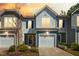 Charming townhome with colorful sunset, a garage, and manicured landscaping enhancing curb appeal at 1020 Sycaten St, Durham, NC 27703