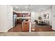 An open-concept kitchen features an island, granite countertops, stainless steel appliances, and a dining area at 1020 Sycaten St, Durham, NC 27703