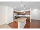 Kitchen features an island with granite countertops, wooden cabinets, and stainless steel appliances at 1020 Sycaten St, Durham, NC 27703