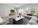 Living room with neutral paint, ceiling fan, sliding glass doors to the backyard, and staircase at 1020 Sycaten St, Durham, NC 27703