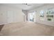 Bright living room with carpet, large windows, and access to the outdoor space through sliding glass doors at 1020 Sycaten St, Durham, NC 27703