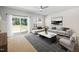 Living room features neutral paint, ceiling fan, and sliding glass doors to the backyard at 1020 Sycaten St, Durham, NC 27703