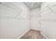 Walk-in closet with metal shelving and carpeted floor, offering ample storage space at 1020 Sycaten St, Durham, NC 27703