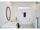 Well-lit bathroom featuring a freestanding tub, modern fixtures, and a large window with a minimalist design at 107 Hillcrest Ave # C And D, Carrboro, NC 27510