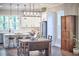 Dining area with vintage wooden table and open view to a bright kitchen featuring white cabinets and modern stainless steel appliances at 107 Hillcrest Ave # C And D, Carrboro, NC 27510