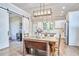 Dining area featuring a vintage wooden table, modern light fixture, and sliding barn door connecting the dining room to the kitchen at 107 Hillcrest Ave # C And D, Carrboro, NC 27510