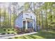 Charming two-story home featuring blue siding, a covered front porch, manicured landscaping and an additional small storage building at 107 Hillcrest Ave # C And D, Carrboro, NC 27510
