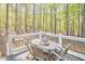 Outdoor deck area with wooden furniture set, surrounded by tall trees and lush greenery, creating a serene setting at 107 Hillcrest Ave # C And D, Carrboro, NC 27510