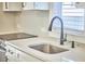 Close-up on kitchen area with modern fixtures, quartz countertops, stainless steel sink, and sleek faucet at 107 Hillcrest Ave # C And D, Carrboro, NC 27510