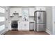 Modern kitchen features stainless steel appliances, white cabinets, quartz countertops, and hardwood floors at 107 Hillcrest Ave # C And D, Carrboro, NC 27510