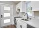 Modern kitchen featuring white cabinets, quartz countertops, stainless steel appliances, and hardwood floors at 107 Hillcrest Ave # C And D, Carrboro, NC 27510