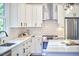 Bright kitchen features white cabinets, stainless appliances and large island with seating at 107 Hillcrest Ave # C And D, Carrboro, NC 27510