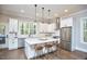 Bright kitchen features white cabinets, stainless appliances, large island with seating and view to the backyard at 107 Hillcrest Ave # C And D, Carrboro, NC 27510