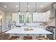 Bright kitchen features white cabinets, a large island with seating, stainless appliances and large windows at 107 Hillcrest Ave # C And D, Carrboro, NC 27510