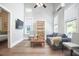 Bright living room with hardwood floors, high ceilings, modern furnishings, and a view into the bedroom at 107 Hillcrest Ave # C And D, Carrboro, NC 27510