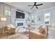 Bright living room featuring a modern fireplace with hexagon tile, hardwood floors, and multiple windows providing natural light at 107 Hillcrest Ave # C And D, Carrboro, NC 27510