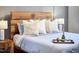 Close-up of a well-appointed bed with decorative pillows and a bottle of champagne, showcasing luxury and comfort at 107 Hillcrest Ave # C And D, Carrboro, NC 27510