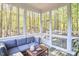 Cozy screened porch with comfortable seating, offering a relaxing view of the surrounding trees and the outside deck at 107 Hillcrest Ave # C And D, Carrboro, NC 27510