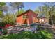 Aerial view of the backyard showcasing the patio, garden, and the home's exterior with lush greenery at 1109 Huntington Ave, Durham, NC 27707