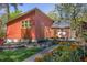 Charming backyard view showcasing modern siding, stone firepit, lush garden, and outdoor deck at 1109 Huntington Ave, Durham, NC 27707
