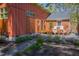 Charming backyard garden with lush plants, stone pathways, and a cozy patio area with chairs for relaxing at 1109 Huntington Ave, Durham, NC 27707
