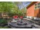 Picture of the backyard patio showcasing a seating area with a fire pit and lush greenery around the perimeter at 1109 Huntington Ave, Durham, NC 27707
