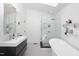 Modern bathroom with a glass shower, freestanding tub, and black and white tile flooring at 1109 Huntington Ave, Durham, NC 27707